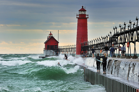 Surfers jumping in Lake MIchigan