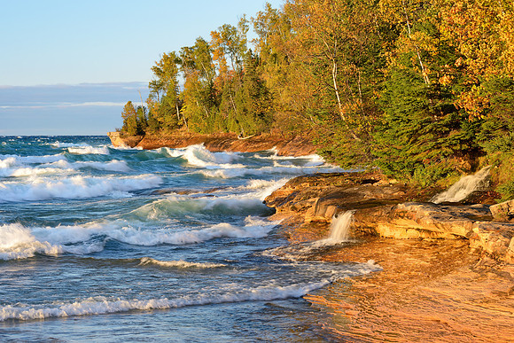 Big waves rolling in a Miners Beach, Elliot Falls spills into Lake Superior